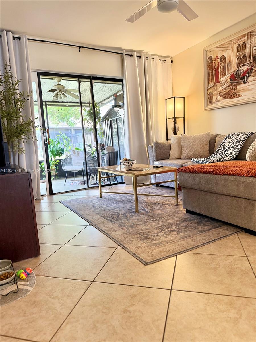 a living room with furniture and a floor to ceiling window