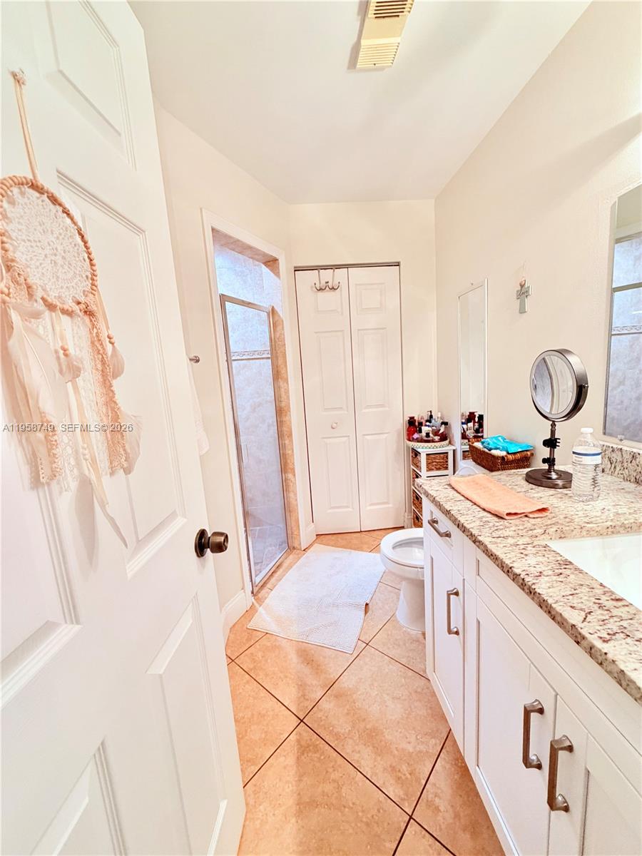 3370 Beau Rivage Drive, Unit 4Q Pompano Beach, FL 33064 - Photo 12 of 31 a spacious bathroom with a granite countertop sink and a mirror