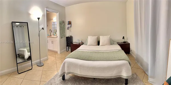 a bedroom with a bed and walk in closet