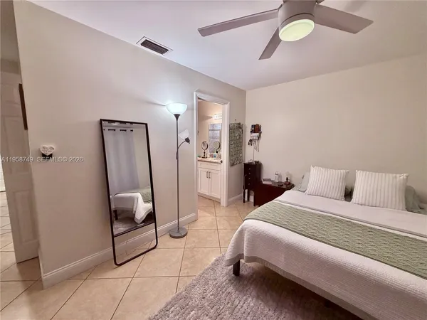 a bedroom with bed and a chandelier