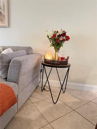 a living room with a couch and a potted plant