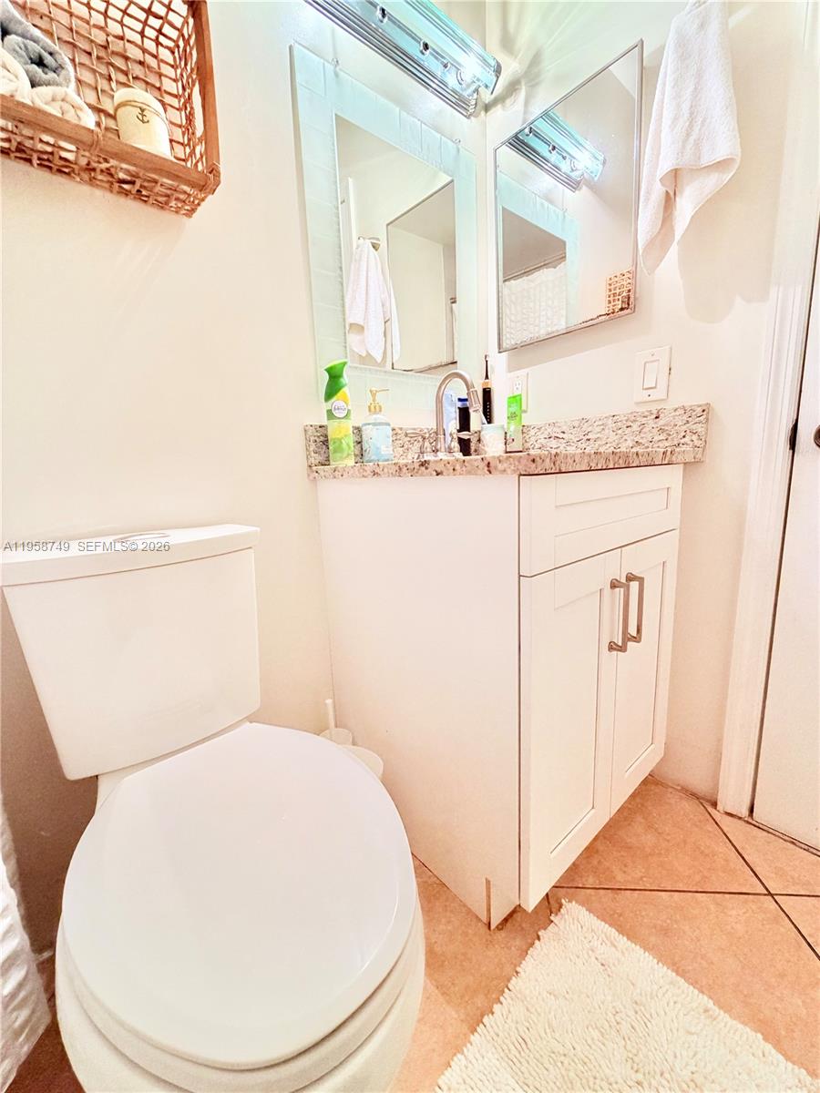 3370 Beau Rivage Drive, Unit 4Q Pompano Beach, FL 33064 - Photo 6 of 31 a bathroom with a sink and a mirror