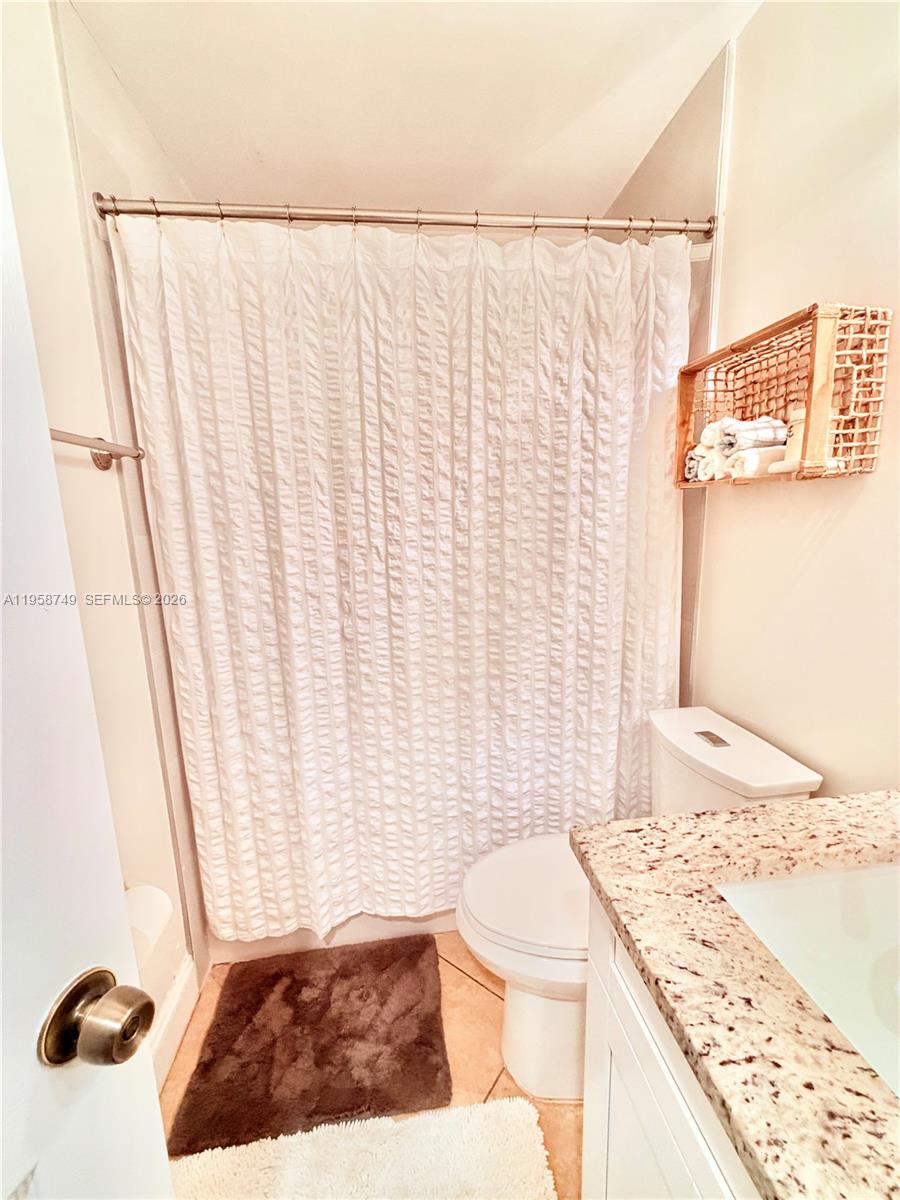3370 Beau Rivage Drive, Unit 4Q Pompano Beach, FL 33064 - Photo 8 of 31 a bathroom with a granite countertop sink and a mirror