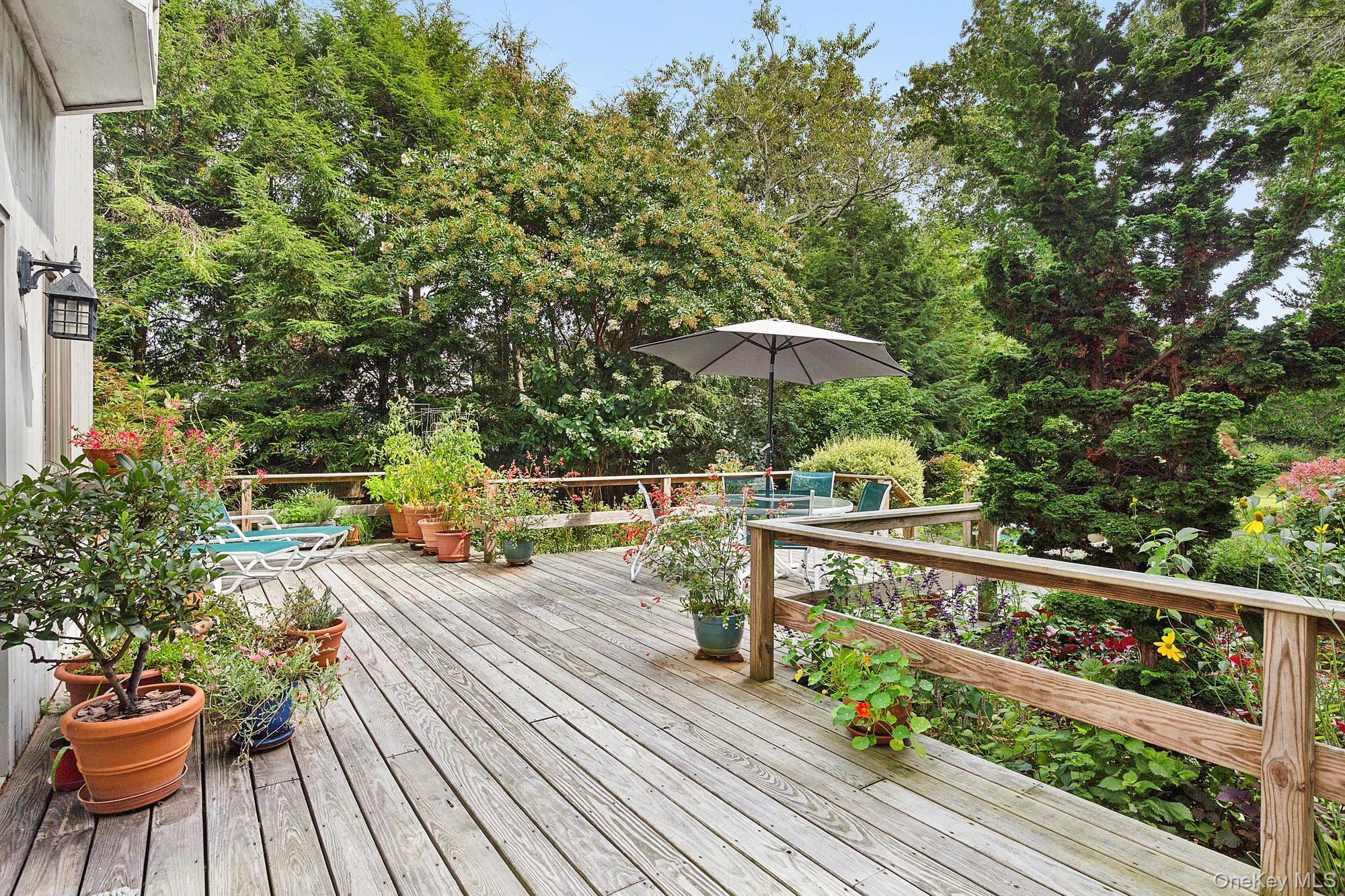 a view of a chairs and table on the wooden deck