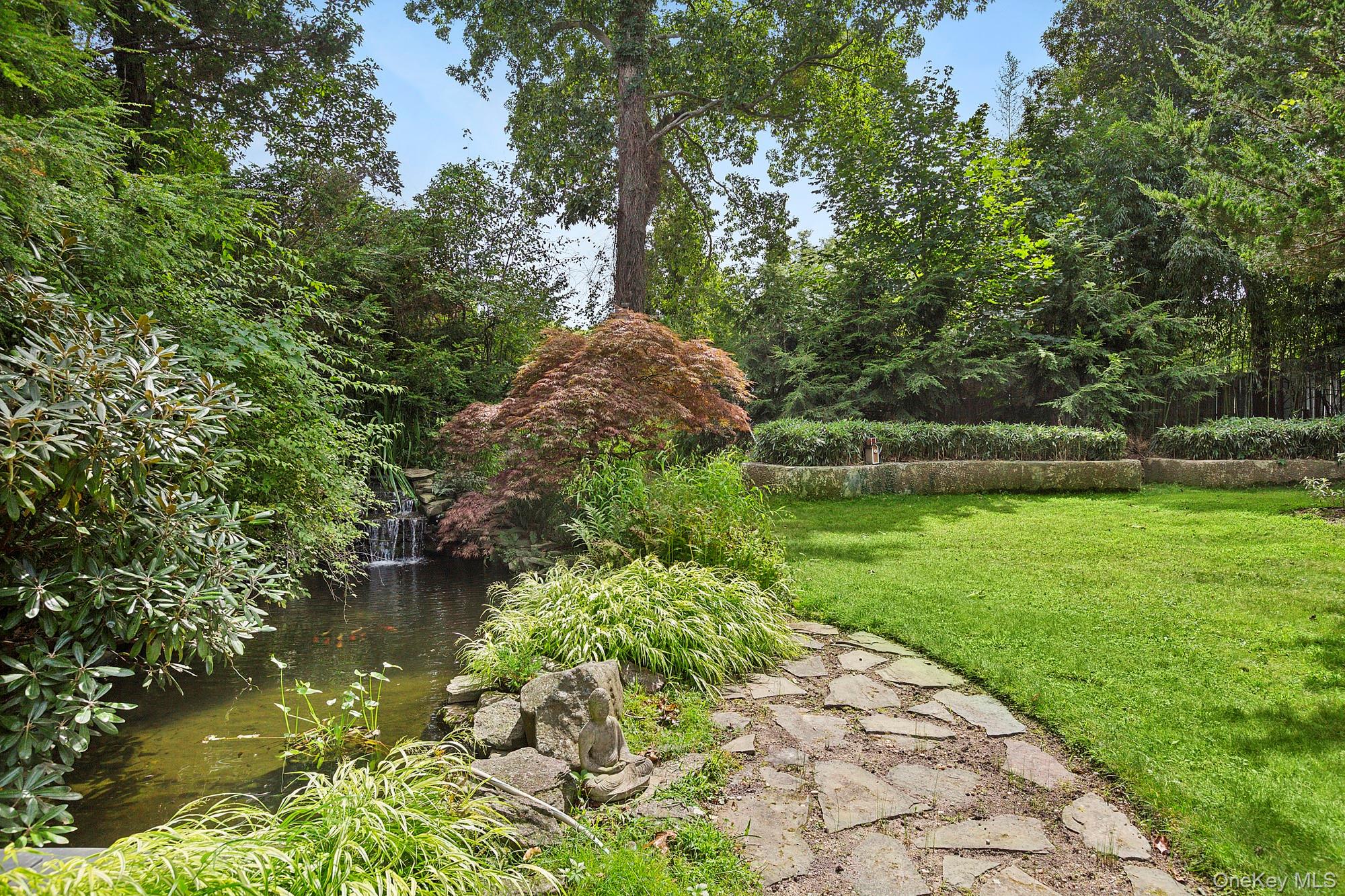 4528 Noyack Road Sag Harbor, NY 11963 - Photo 13 of 13 a view of a lake with a bench