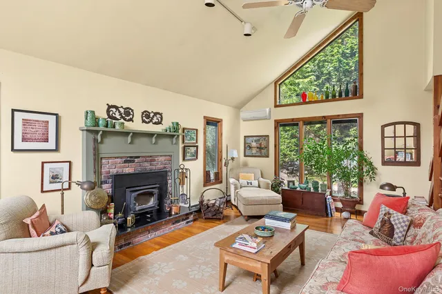 a living room with furniture fireplace and a large window