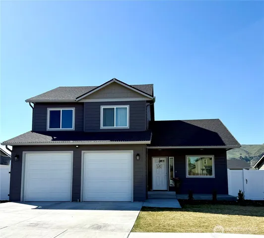 a front view of a house with yard