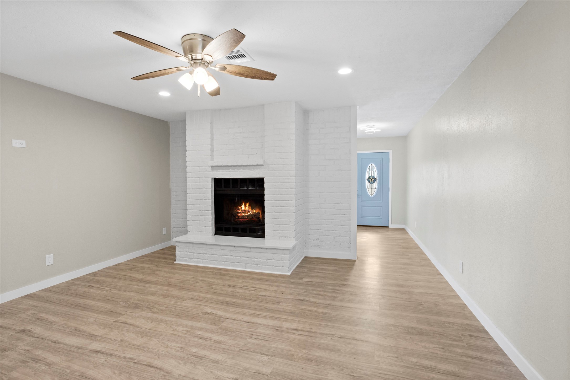 10127 Tolman Street Houston, TX 77034 - Photo 5 of 27 This living room combines cozy traditional elements with a clean, updated aesthetic, characterized by its bright white features and open layout.