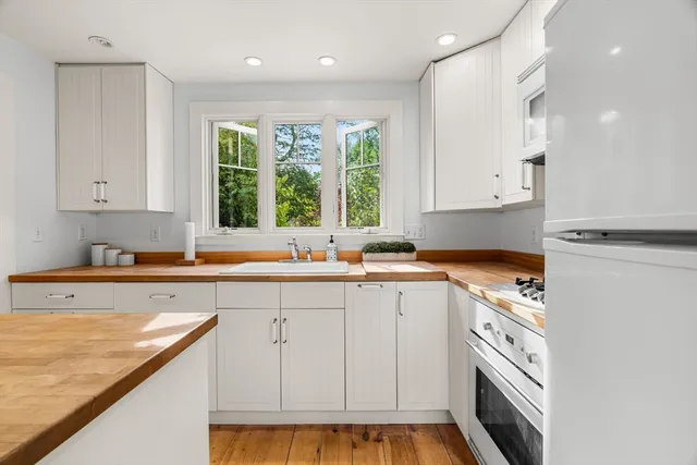 a kitchen with a sink a window and cabinets
