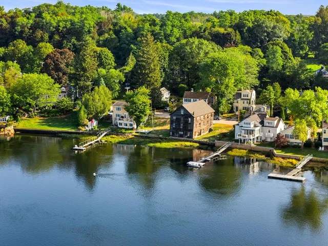 a view of a swimming pool with outdoor seating and lake view