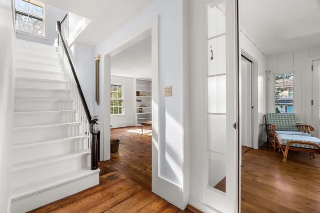 a view of entryway and hall with wooden floor