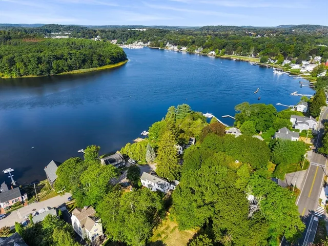 an aerial view of a houses with a lake view