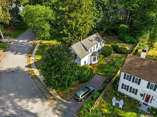 an aerial view of a house with garden space and street view