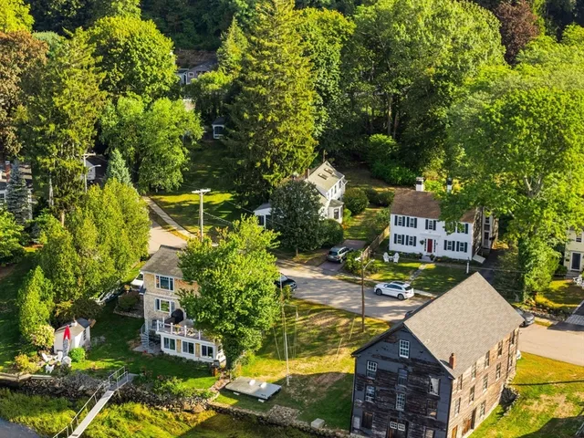 an aerial view of a house with a yard swimming pool a patio and outdoor seating
