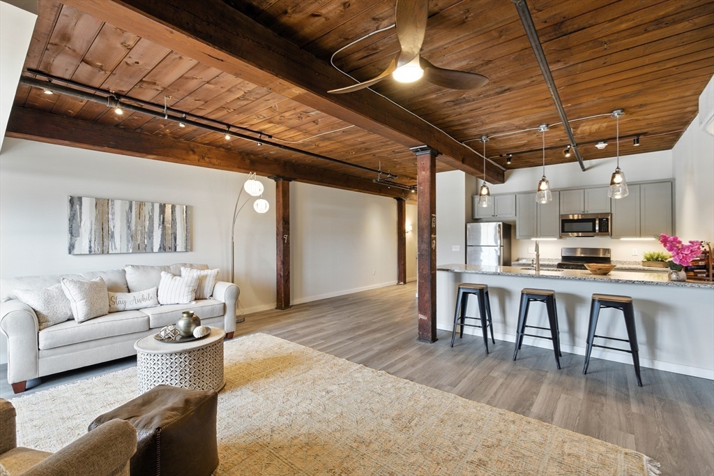 55 Sterling Street, Unit 314 Clinton, MA 01510 - Photo 1 of 36 a living room with furniture and a wooden floor