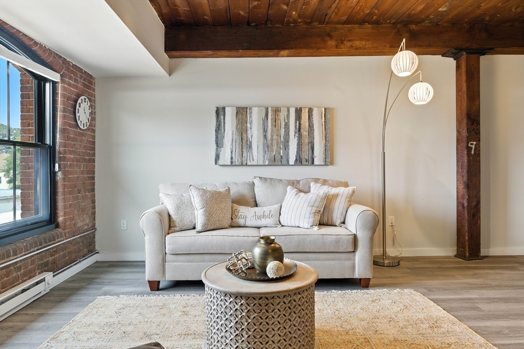 55 Sterling Street, Unit 314 Clinton, MA 01510 - Photo 12 of 36 a living room with furniture and a window