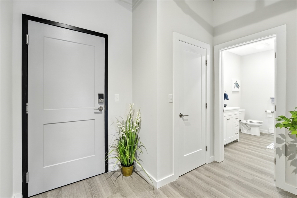 55 Sterling Street, Unit 314 Clinton, MA 01510 - Photo 15 of 36 a view of a hallway with wooden floor and a closet