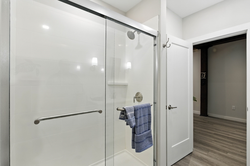 55 Sterling Street, Unit 314 Clinton, MA 01510 - Photo 17 of 36 a bathroom with a shower and a mirror