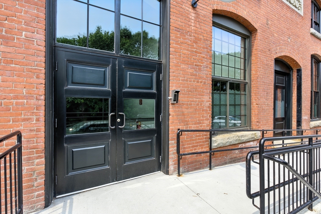 55 Sterling Street, Unit 314 Clinton, MA 01510 - Photo 4 of 36 a view of a brick house with a large window
