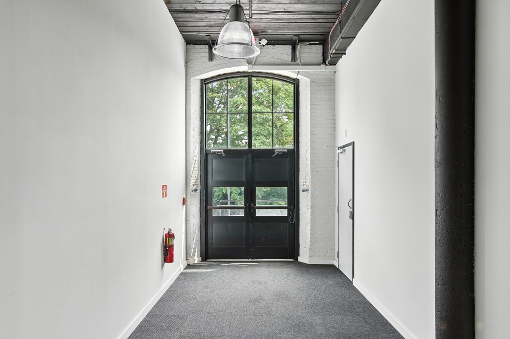 55 Sterling Street, Unit 314 Clinton, MA 01510 - Photo 5 of 36 a view of empty room with floor to ceiling window
