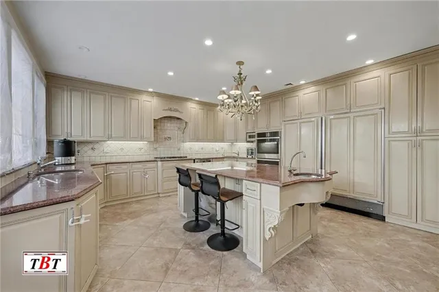 a kitchen with stainless steel appliances granite countertop a sink stove and cabinets
