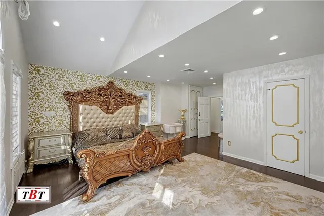 a spacious bedroom with a bed window and glass door