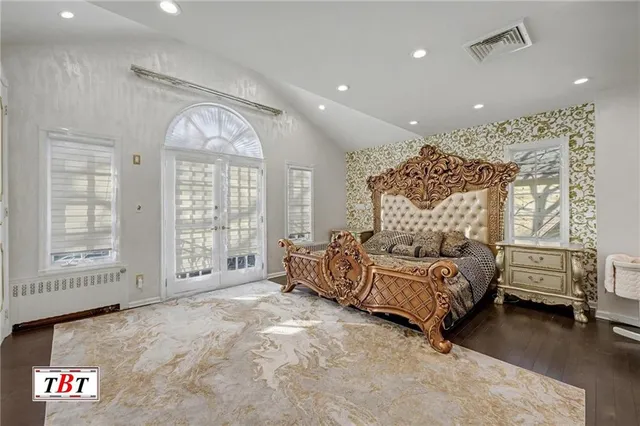 a bedroom with a large bed and a window