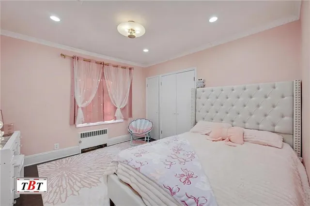 a bedroom with a bed and a television