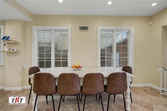 a view of a bedroom with wooden floor and a ceiling fan