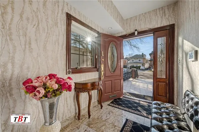 a living room with furniture a flat screen tv and a book shelf