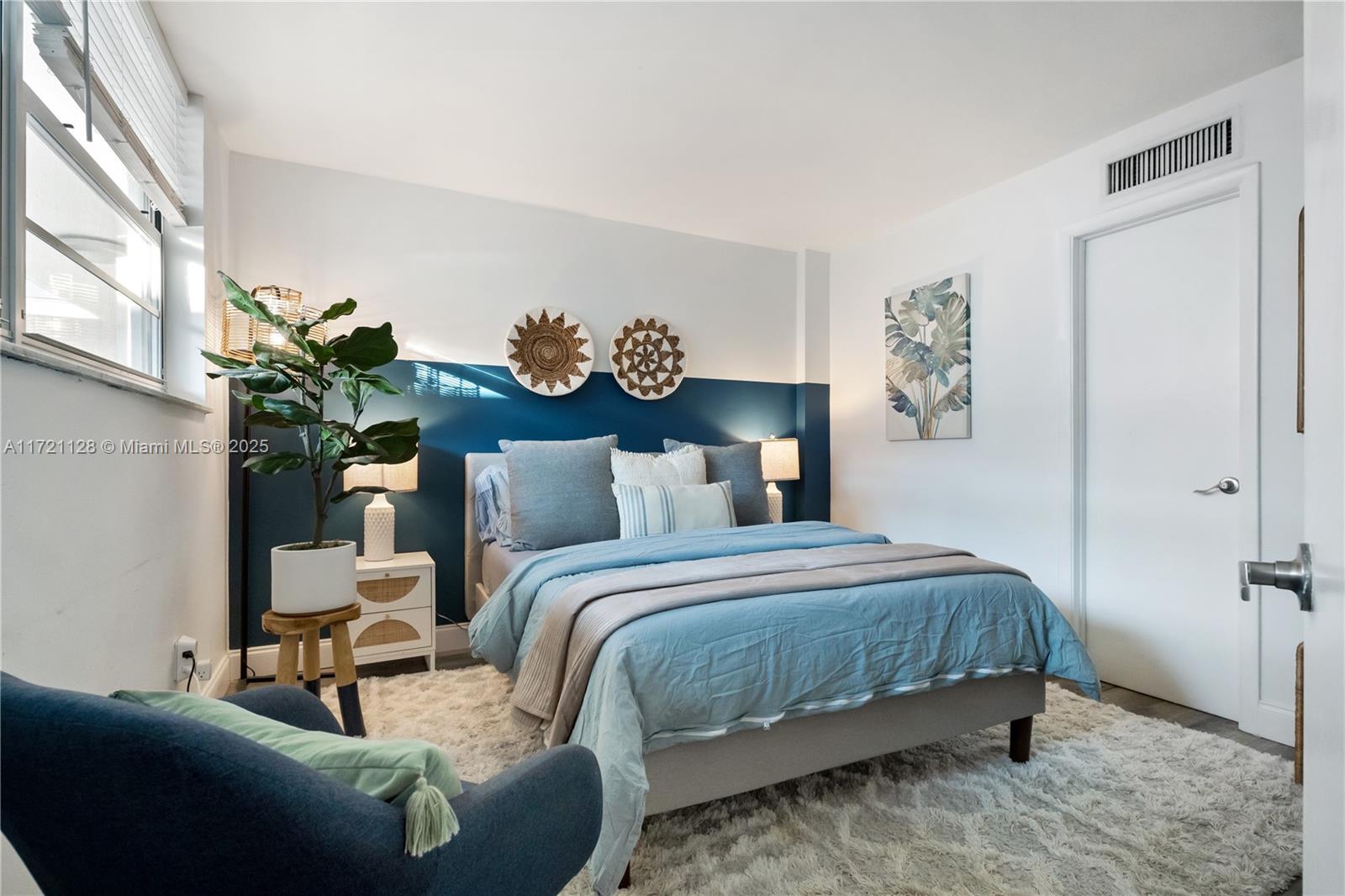 750 Northeast 64th Street, Unit B504 Miami, FL 33138 - Photo 18 of 37 a bedroom with a bed table and a couch