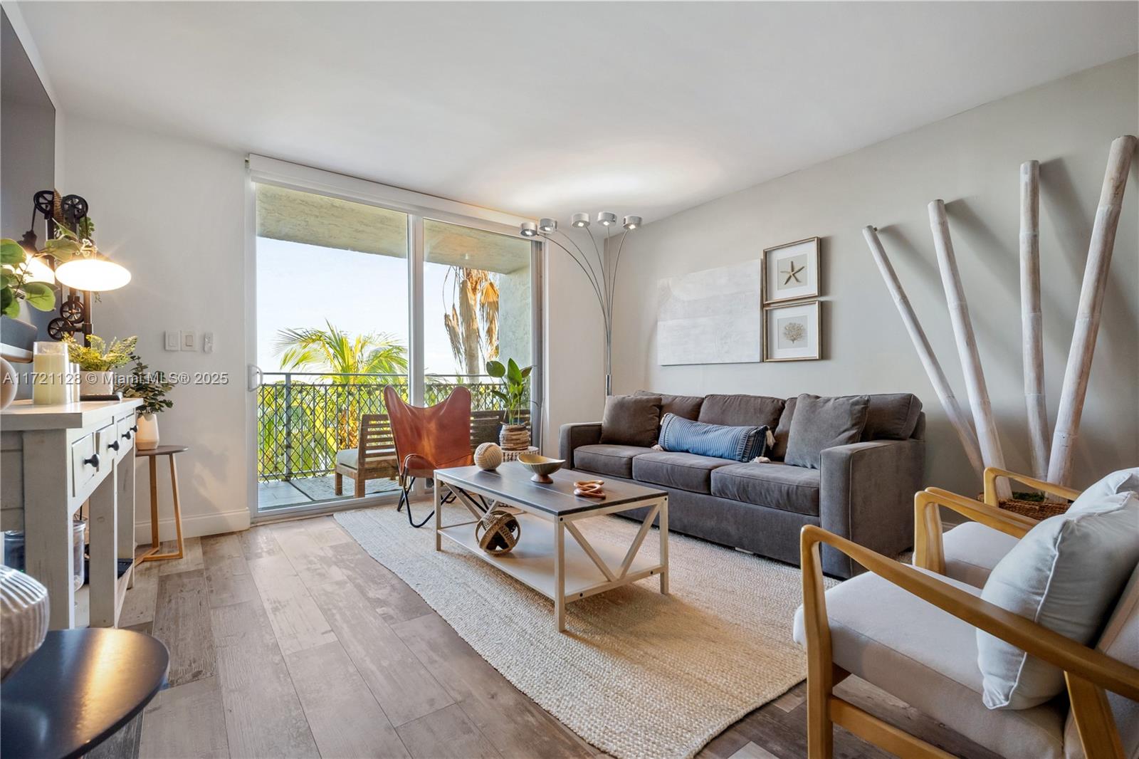 750 Northeast 64th Street, Unit B504 Miami, FL 33138 - Photo 3 of 37 a living room with furniture a large window and a flat screen tv
