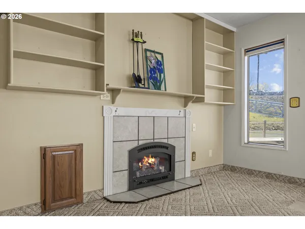 a living room with a fireplace and a window