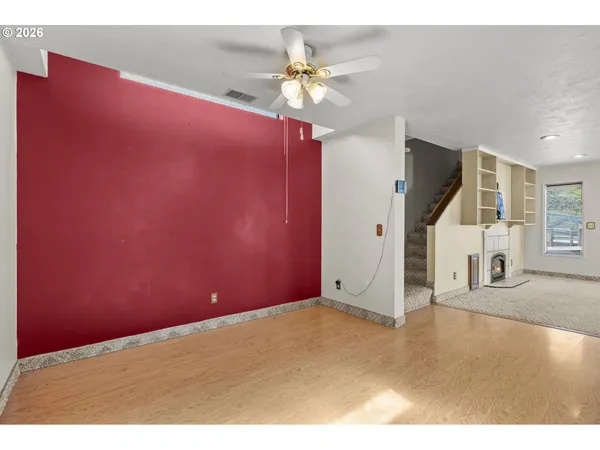 a view of a livingroom with a ceiling fan and window