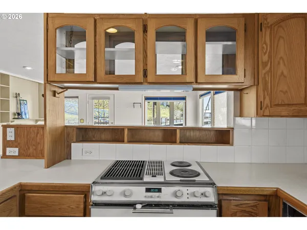 a bathroom with a granite countertop sink toilet a mirror and shower