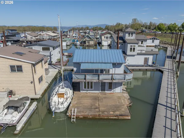 a view of a house with pool and chairs