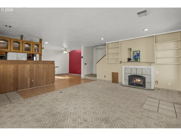 a view of a livingroom with a fireplace and cabinet