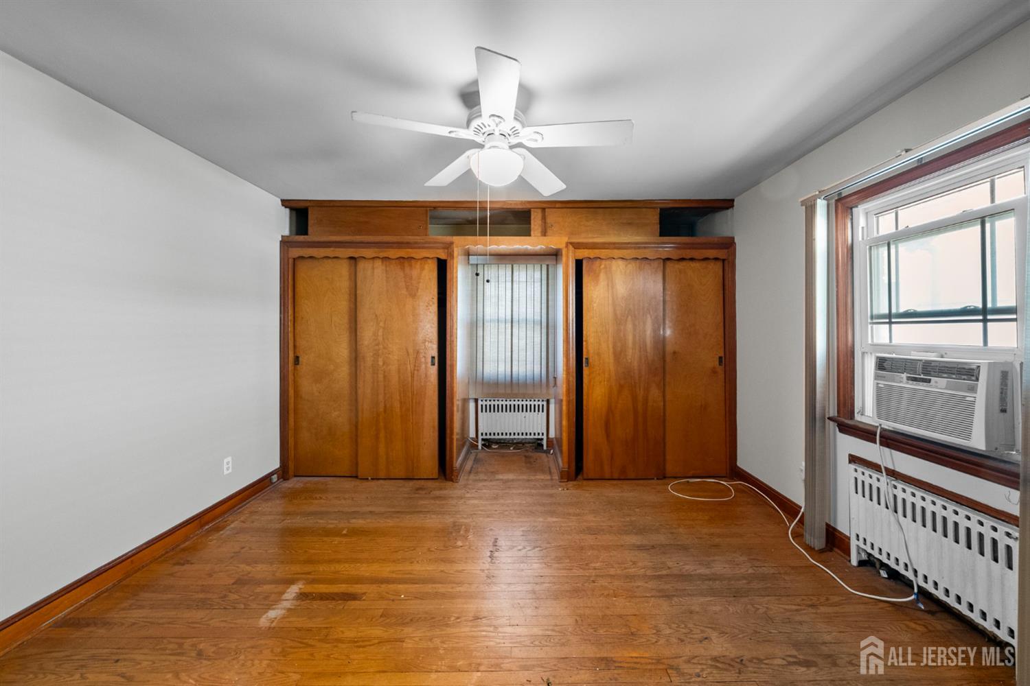 926 Hermann Road North Brunswick, NJ 08902 - Photo 12 of 54 wooden floor in an empty room with a window