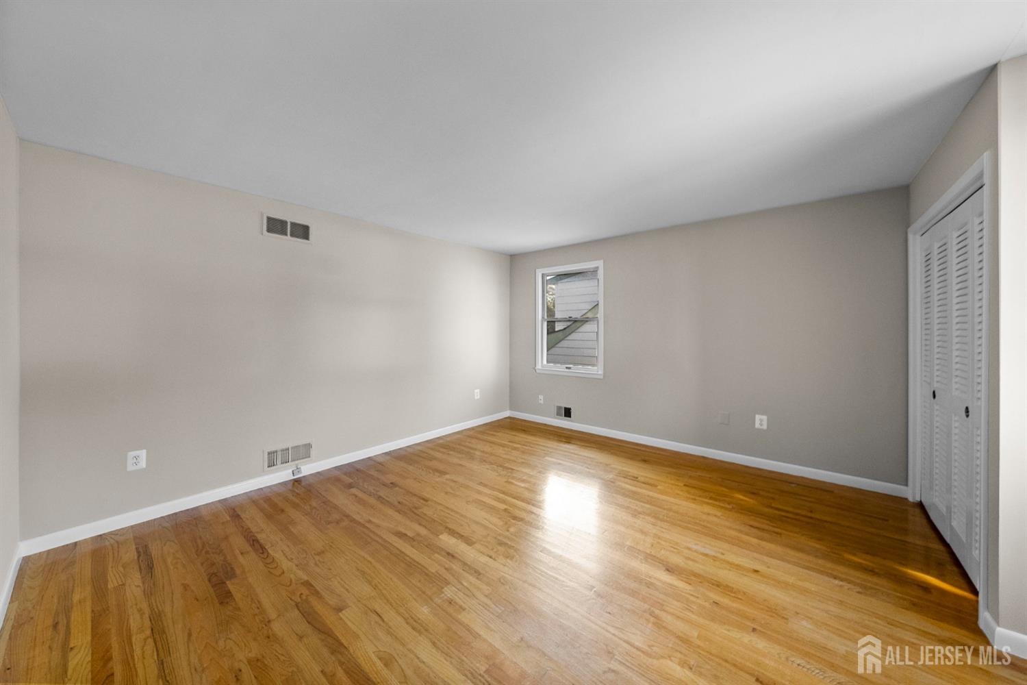 926 Hermann Road North Brunswick, NJ 08902 - Photo 17 of 54 a view of empty room with wooden floor