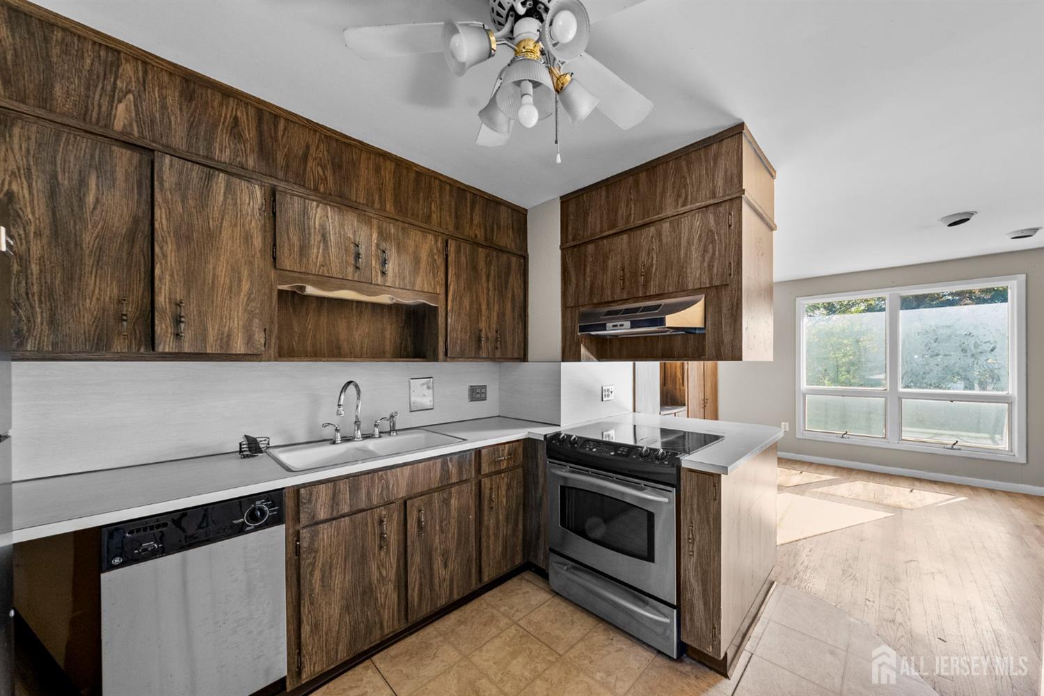 926 Hermann Road North Brunswick, NJ 08902 - Photo 24 of 54 a kitchen with stainless steel appliances a sink stove and cabinets