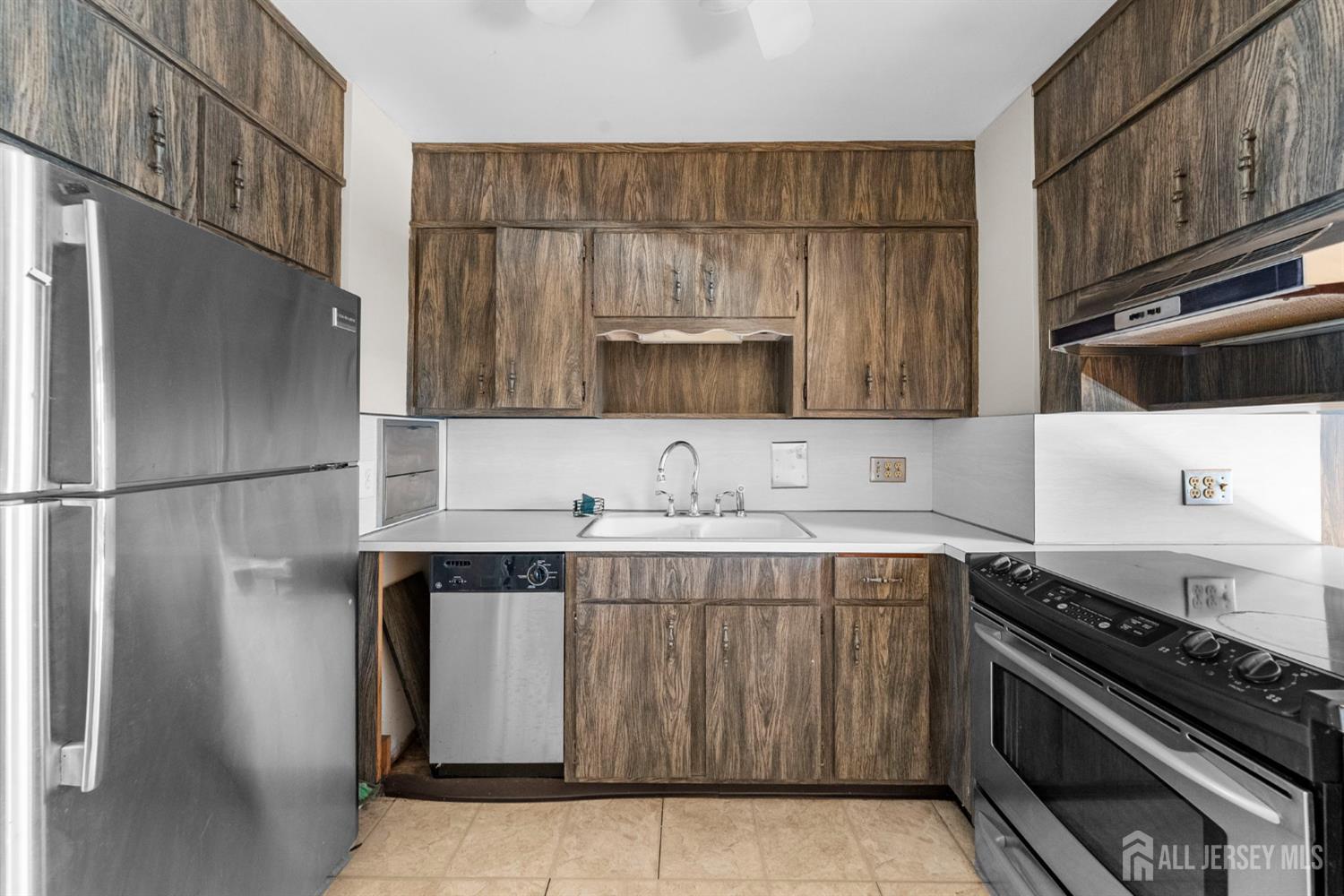 926 Hermann Road North Brunswick, NJ 08902 - Photo 25 of 54 a kitchen with stainless steel appliances granite countertop a sink stove and refrigerator