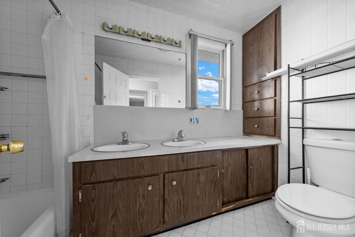 926 Hermann Road North Brunswick, NJ 08902 - Photo 26 of 54 a bathroom with a toilet a sink and mirror