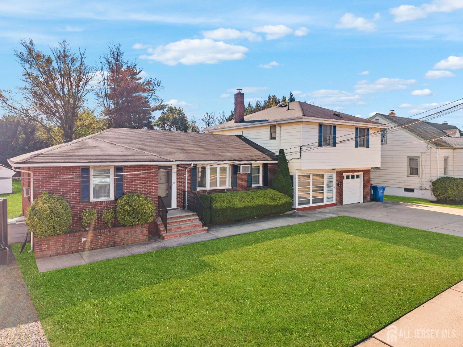 926 Hermann Road North Brunswick, NJ 08902 - Photo 3 of 54 a front view of a house with a garden