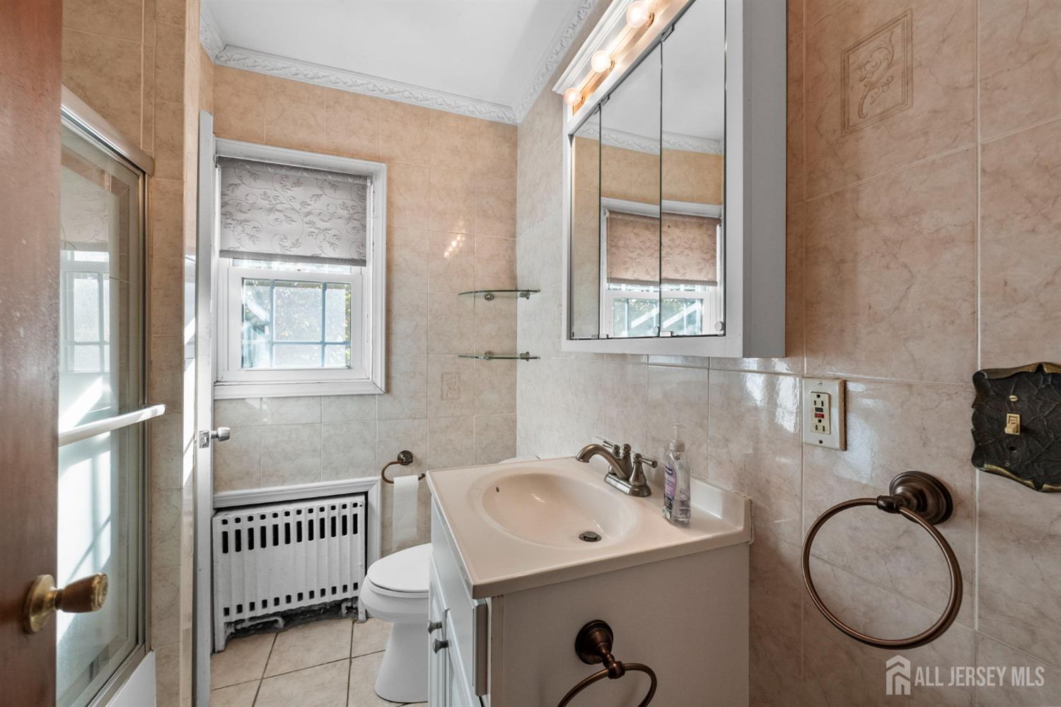 926 Hermann Road North Brunswick, NJ 08902 - Photo 40 of 54 a bathroom with a sink and a mirror