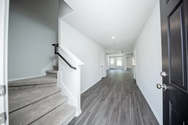 a view of a hallway view with wooden floor and staircase