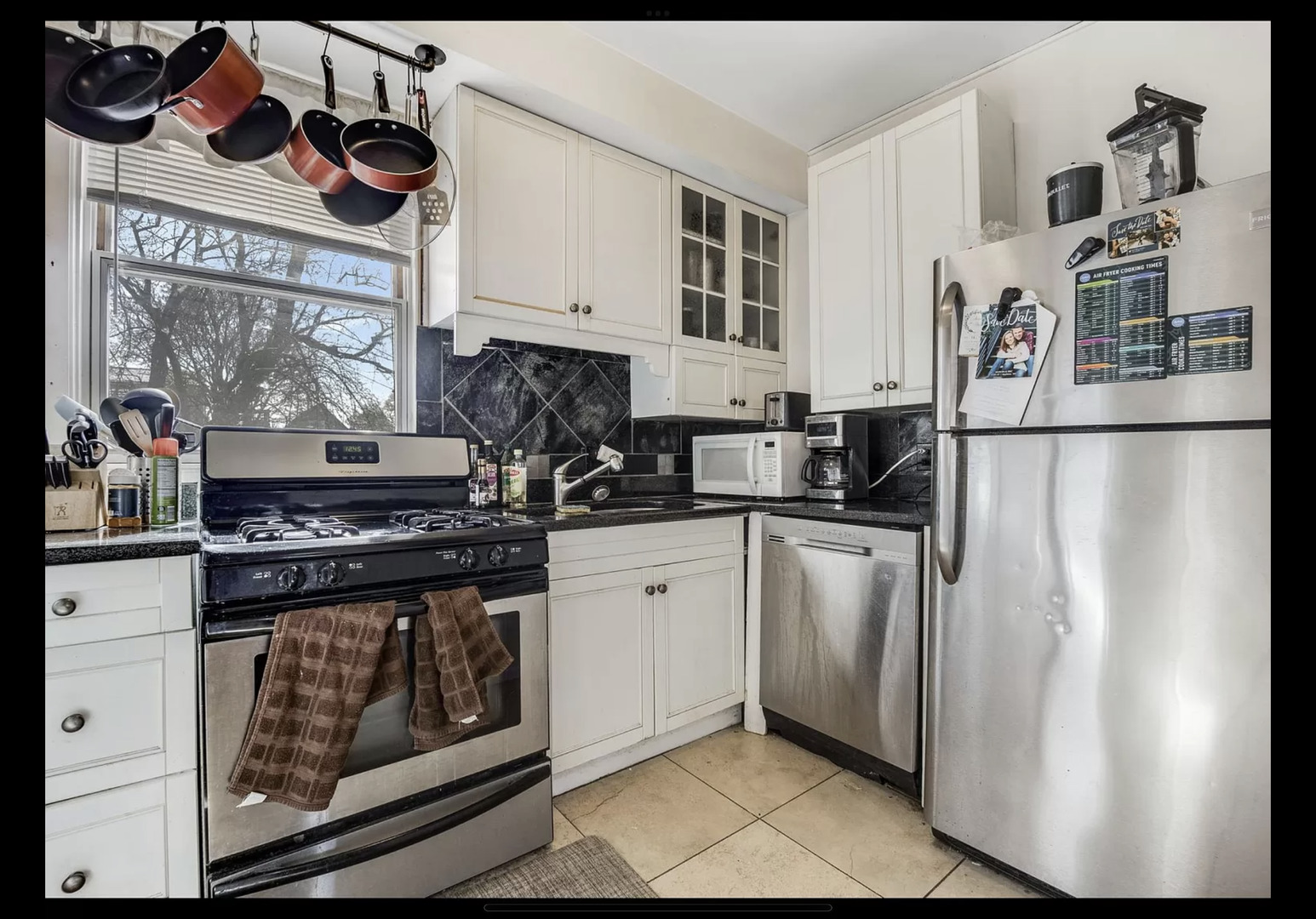Undisclosed Address Chicago, IL 60657 - Photo 2 of 10 a kitchen with stainless steel appliances granite countertop a stove a refrigerator and a microwave