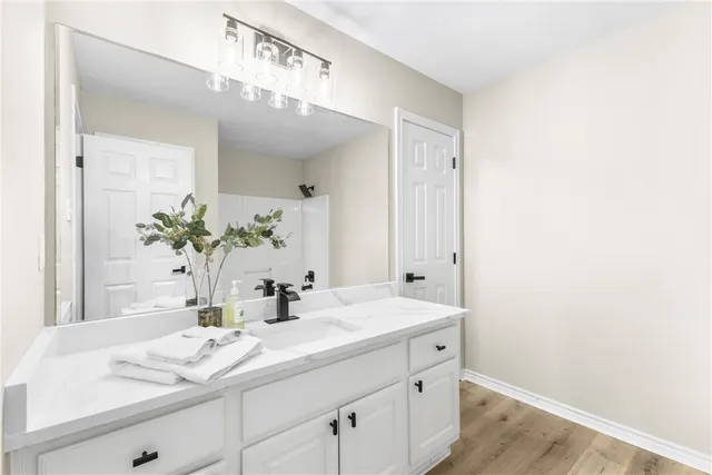 a bathroom with a sink a vanity and a mirror