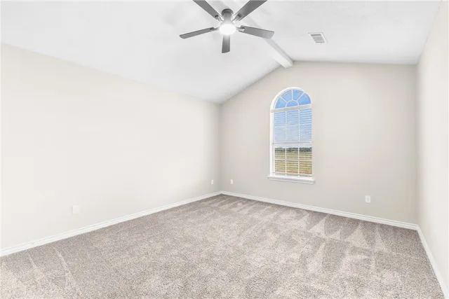 an empty room with a window and a ceiling fan