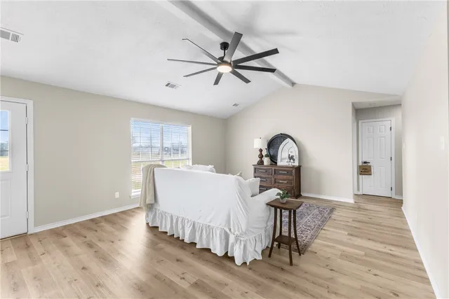 a view of a livingroom with furniture and a ceiling fan