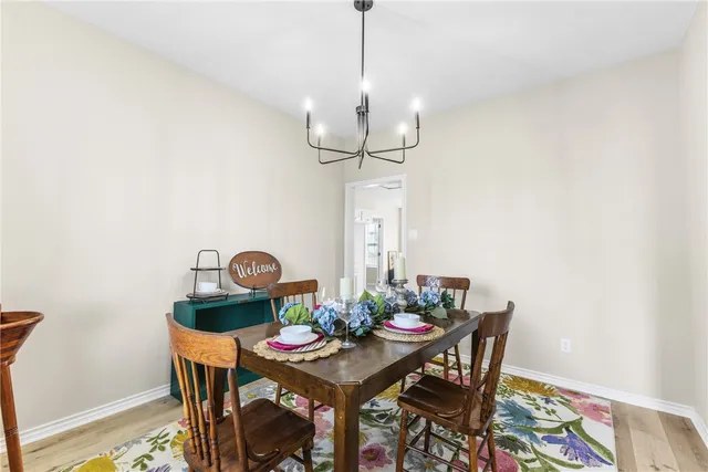a view of a dining room with a table and chairs
